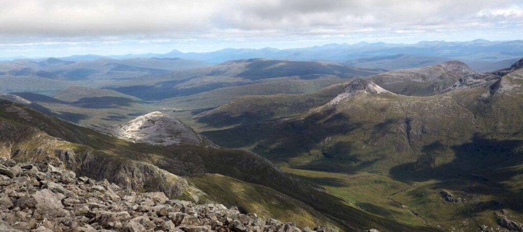photo overlooking Carn Mor Dearg Arete and Fort William in Scotland while climbing Ben Nevis on an overcast day with low clouds
