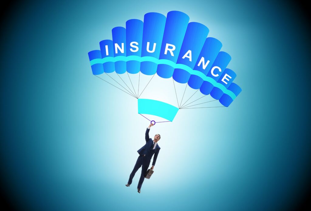 a picture of an insurance agent with a suitcase flying in a blue parachute with "insurance" written on it