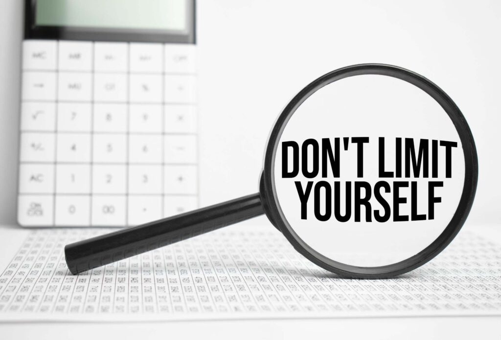 a magnifying glass with "don't limit yourself" written inside it.