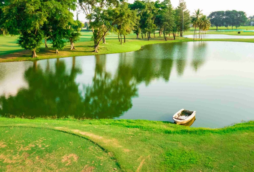 picture of a golf course with a lake and greens of a medium priced golf club