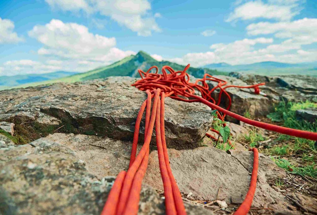 photo of the red climbing ropes lying at the top of the hill on the rocks