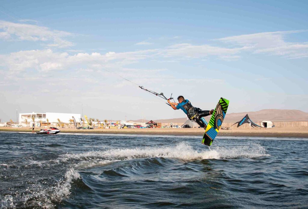 photo of a professional athlete performing a trick while kitesurfing