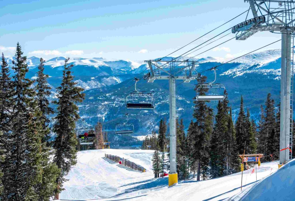 photo of ski elevators against the backdrop of beautiful snowy mountains