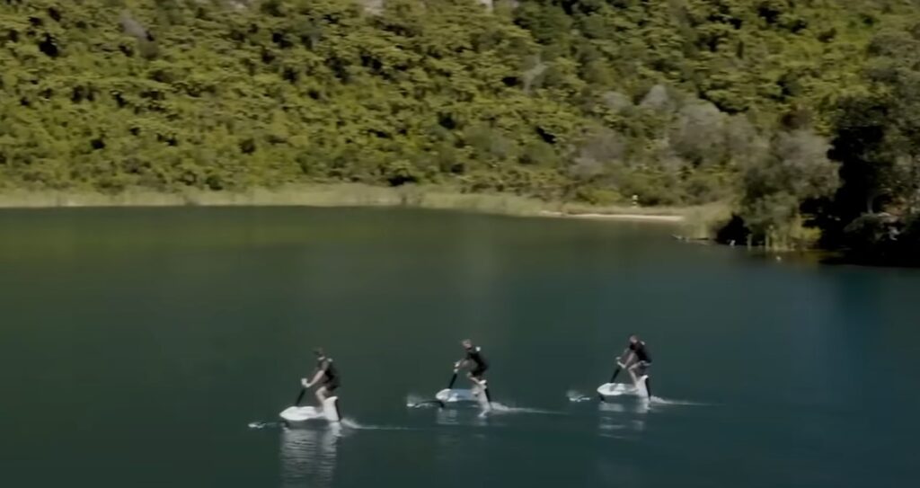 3 man riding a water bicycle on the water